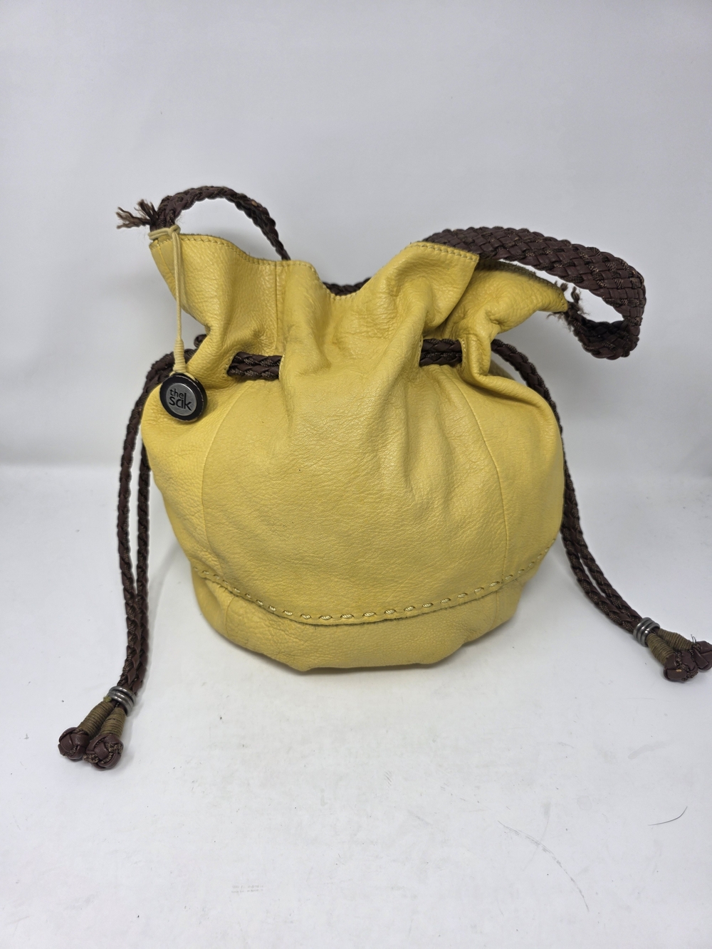 The Sak Yellow Pebble Leather Drawstring Bucket Bag Braided Shoulder Strap Purse